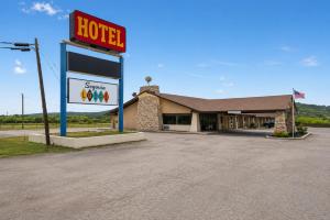 a hotel sign in front of a gas station at Segovia Lodge Junction TX I -10 in Junction