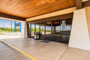 a building with glass doors and a wooden ceiling at Segovia Lodge Junction TX I -10 in Junction +29 photos