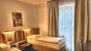 a hotel room with two beds and a window at Hotel Boss in Žilina +48 photos