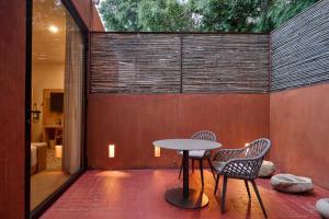 a patio with a table and two chairs at Casa Carmen Reforma in Oaxaca City
