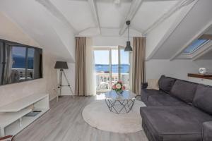 a living room with a couch and a table at Villa Vita luxury Apartments in Crikvenica