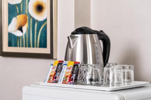 a coffee pot sitting on top of a shelf at Sawasdee Siam Pattaya Hotel in Pattaya +12 photos