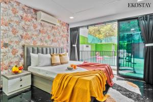 a bedroom with a bed and a large window at EKOSTAY - ONYX Villa in Mumbai +20 photos