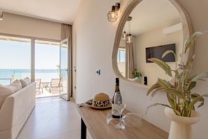a living room with a table and a mirror at Blue Horizon Studios in Laganas