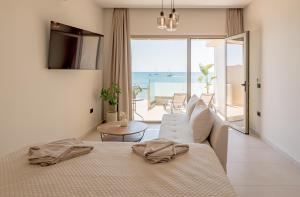 a bedroom with a bed and a view of the ocean at Blue Horizon Studios in Laganas