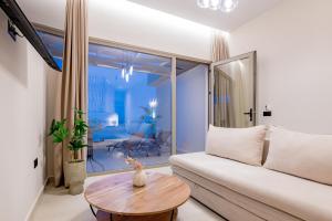 a living room with a couch and a table at Blue Horizon Studios in Laganas +55 photos