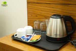 a coffee maker on a tray on a counter at Pacific Inn Vistaar Hotels & Resorts in Chamba