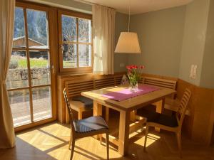 a dining room table with a vase of flowers on it at Familie Jäger in Innerbraz