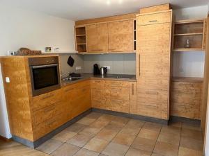 a kitchen with wooden cabinets and a counter top at Familie Jäger in Innerbraz +19 photos