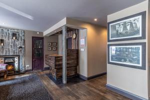 a hallway with a living room with a fireplace at Lochside Hotel in Bowmore
