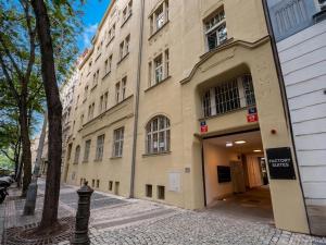 a large building on a street next to a sidewalk at Factory Suites in Prague