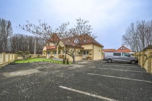 a van parked in a parking lot in front of a house at Palmy Home Ecser in Ecser +115 photos