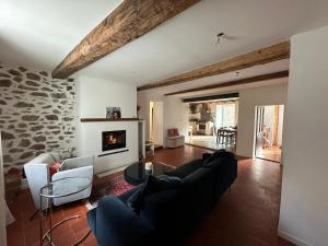 a living room with a couch and a fireplace at Fajureya House in Vaumeilh