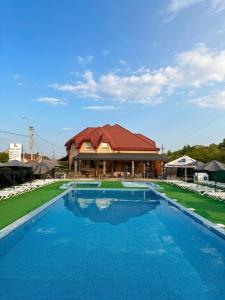 a large swimming pool in front of a building at Aqua Hotel in Solotvyno