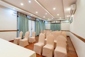 a conference room with white chairs and tables at The Culture Resort in Pokhara +75 photos