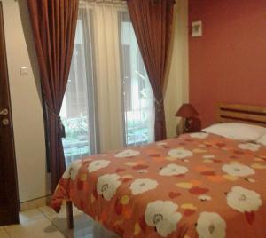 Voodi või voodid majutusasutuse Aloha Hotel Yogyakarta toas