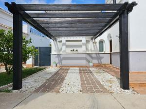 a wooden pergola in front of a white house at Villa with private pool and jacuzzi - EN10LT in Torre-Pacheco +56 photos