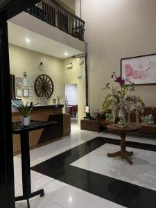 a living room with a staircase and a table at B&S Orchids Suites Hotel in Dipolog