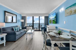 a living room with a couch and a dining room at Condos at the Caribbean Resort in Myrtle Beach