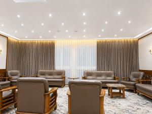 a waiting room with couches and tables and curtains at Maadi Hotel in Cairo +29 photos