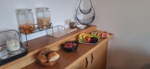 a wooden counter with plates of fruit on it at Hotel Garni in Rodewisch +9 photos