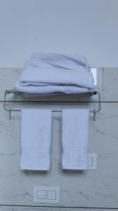 a pile of towels on a rack in a room at Pacific Inn Vistaar Hotels & Resorts in Chamba +53 photos