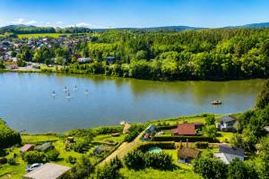 an aerial view of a lake with boats in it at Modrobílá chatka u rybníka in Holoubkov +15 photos