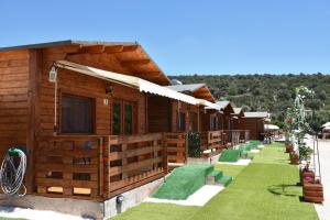 a row of wooden cabins in a resort at Kandia Woodlands in Kandia
