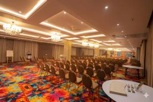 a large room with chairs and tables and a stage at Sawarthia Sewa Sadan, Ayodhya in Ayodhya