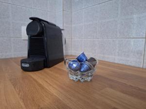 a glass bowl with blue spheres in front of a television at Elia rooms in Neoi Epivates