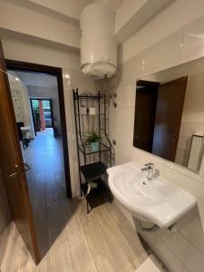 a bathroom with a sink and a mirror and a hallway at Apartments Tajana in Novigrad Istria +99 photos