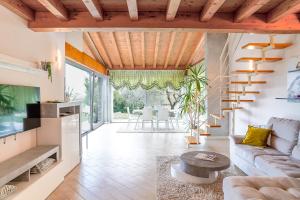 a living room with a couch and a table at Villa Ulivi Private Pool & Lake View in Montinelle
