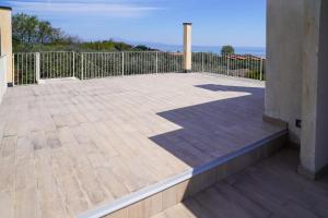 a balcony with a wooden floor and a fence at Villa Ulivi Private Pool & Lake View in Montinelle