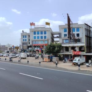 a building on the side of a city street at Hotel Sun City in Kalol