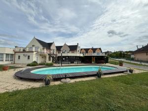 a large house with a swimming pool in the yard at Az Idill in Cserszegtomaj