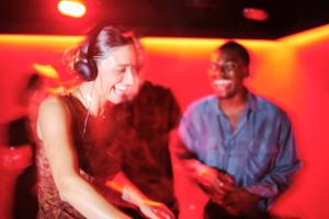 a woman wearing headphones and a man in a red room at Terreno Barrio Hotel in Palma de Mallorca +158 photos