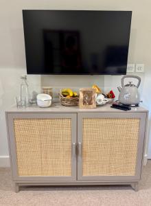 a gray cabinet with a television on top of it at Black Drove Farm in Twenty