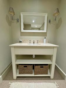 a bathroom with a sink and a mirror at Black Drove Farm in Twenty