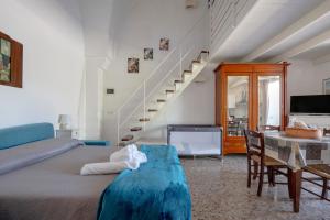 a bedroom with a bed and a table and stairs at Masseria Lamapecora in Faccia di Trippa