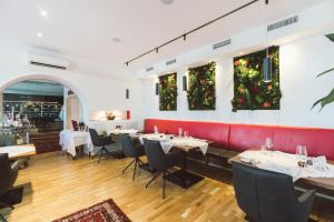 a restaurant with tables and chairs and christmas decorations at Hotel Restaurant Pusswald in Hartberg +33 photos