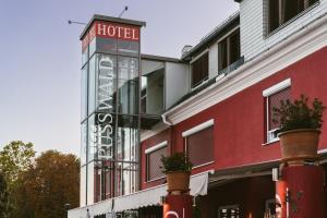 a hotel with a sign on the side of a building at Hotel Restaurant Pusswald in Hartberg