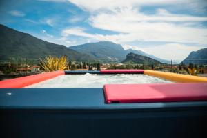 a large water slide with mountains in the background at HOODY ACTIVE & HAPPINESS HOTEL in Arco