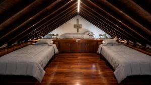 a room with three beds in a church with a cross at Finca La Acequia del Gamonal in Santa Brígida