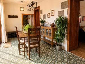 a dining room with a wooden table and chairs at Finca La Acequia del Gamonal in Santa Brígida +18 photos