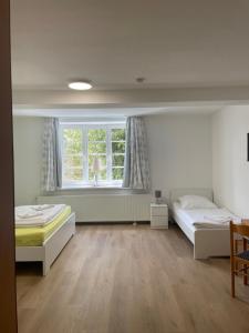 a bedroom with two beds and a window at VITA Ferienresidenz in Neu Kaliß +124 photos