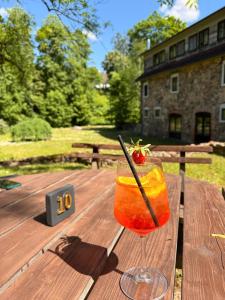 a drink sitting on top of a wooden table at Park Hotel Brūzis in Smiltene
