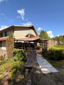 a wooden bench in front of a building at Park Hotel Brūzis in Smiltene