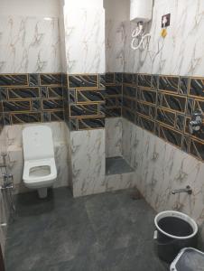 a bathroom with a toilet and a sink at hotel shaurya in Naroda