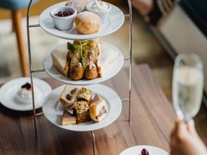 a three tiered tray with plates of food on it at Carlton George Hotel in Glasgow