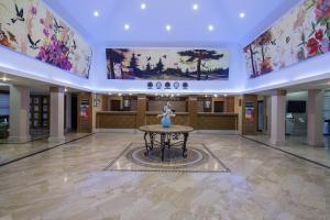 a large lobby with a table and paintings on the ceilings at Crystal Flora Pearl Collection - Ultimate All Inclusive in Beldibi +216 photos